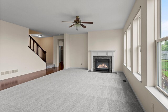 14111 Abercorn Ave, Rosemount, MN 55068 - unfurnished living room featuring carpet, ceiling fan, plenty of natural light, and a premium fireplace