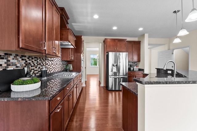 14111 Abercorn Ave, Rosemount, MN 55068 - kitchen with stainless steel appliances, dark wood-style flooring, decorative backsplash, hanging light fixtures, and dark stone counters