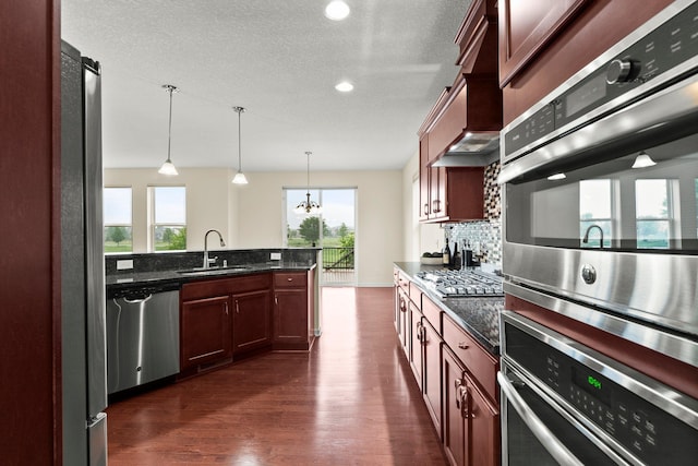 14111 Abercorn Ave, Rosemount, MN 55068 - kitchen with stainless steel appliances, a sink, dark wood-type flooring, pendant lighting, and tasteful backsplash