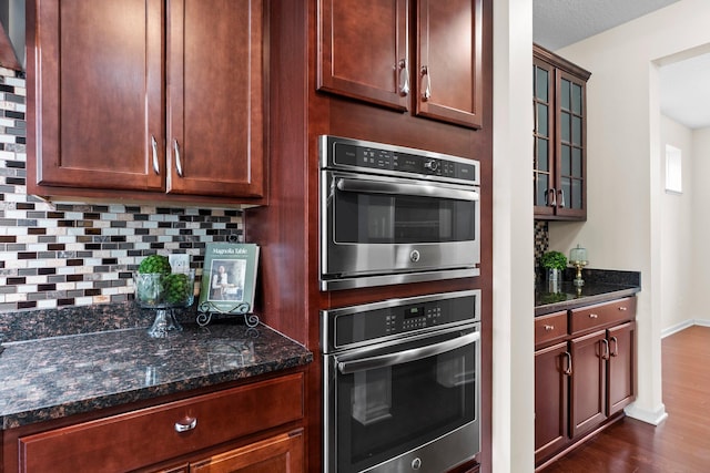 14111 Abercorn Ave, Rosemount, MN 55068 - kitchen with oven, backsplash, dark wood finished floors, and dark stone countertops