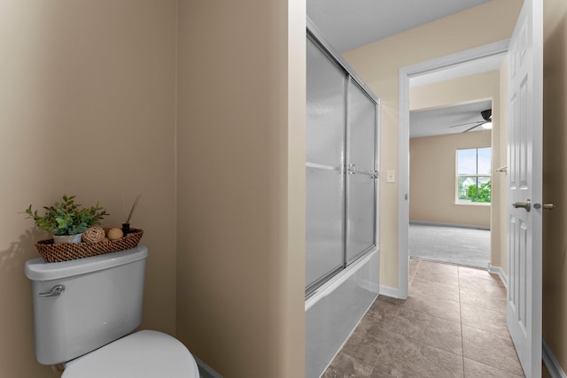 14111 Abercorn Ave, Rosemount, MN 55068 - full bath featuring toilet, a ceiling fan, combined bath / shower with glass door, baseboards, and tile patterned floors