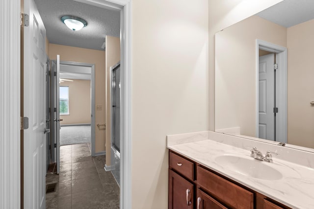 14111 Abercorn Ave, Rosemount, MN 55068 - bathroom featuring vanity, baseboards, and a textured ceiling