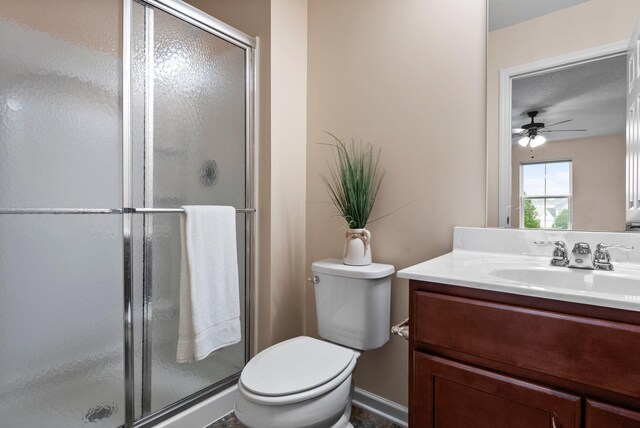 14111 Abercorn Ave, Rosemount, MN 55068 - bathroom featuring vanity, a stall shower, toilet, a ceiling fan, and baseboards