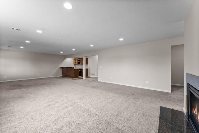 14111 Abercorn Ave, Rosemount, MN 55068 - unfurnished living room featuring carpet floors, a fireplace with flush hearth, baseboards, and recessed lighting