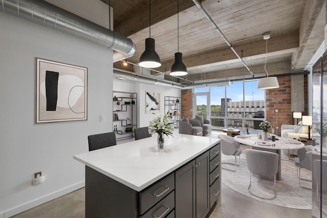 901 3rd St Unit 515, Minneapolis, MN 55401 - kitchen featuring concrete floors, open floor plan, a kitchen island, gray cabinets, and expansive windows