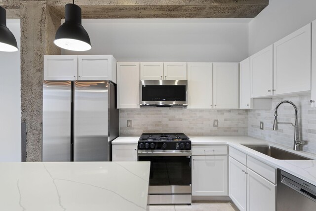 901 3rd St Unit 515, Minneapolis, MN 55401 - kitchen featuring stainless steel appliances, a sink, light stone counters, and white cabinetry
