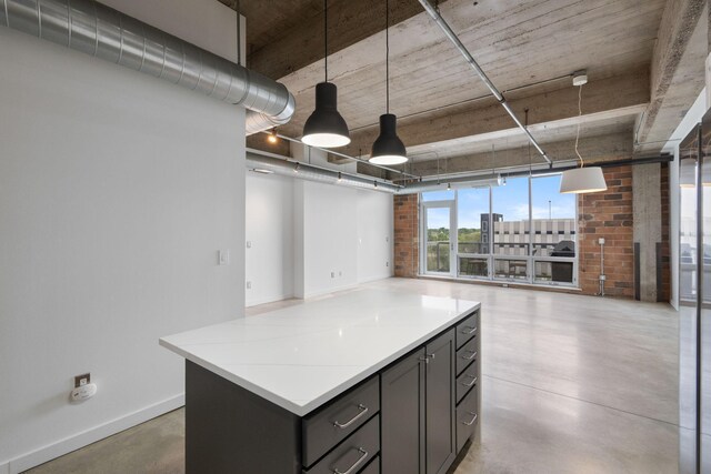 901 3rd St Unit 515, Minneapolis, MN 55401 - kitchen featuring finished concrete floors, gray cabinetry, a kitchen island, baseboards, and open floor plan