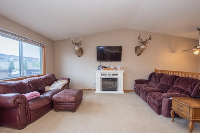 1810 41st Ave S, Moorhead, MN 56560 - living room featuring light carpet, ceiling fan, vaulted ceiling, and a fireplace