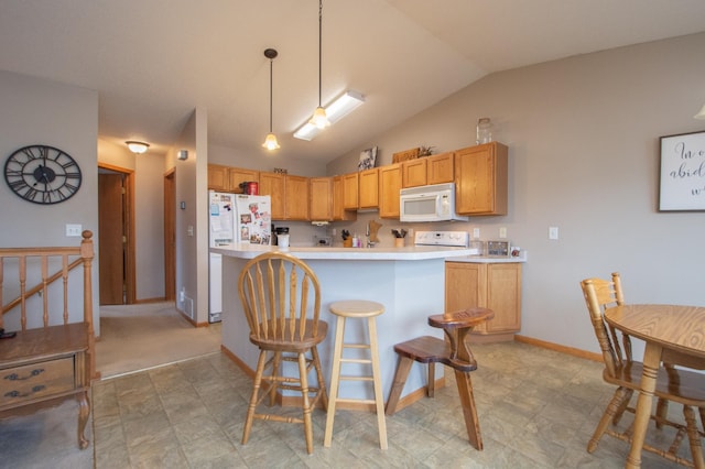 1810 41st Ave S, Moorhead, MN 56560 - kitchen with white appliances, lofted ceiling, light countertops, a center island, and decorative light fixtures
