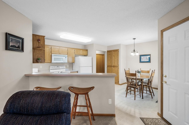 12 3rd St NW, Saint Michael, MN 55376 - kitchen featuring white appliances, a peninsula, light colored carpet, a chandelier, and light countertops