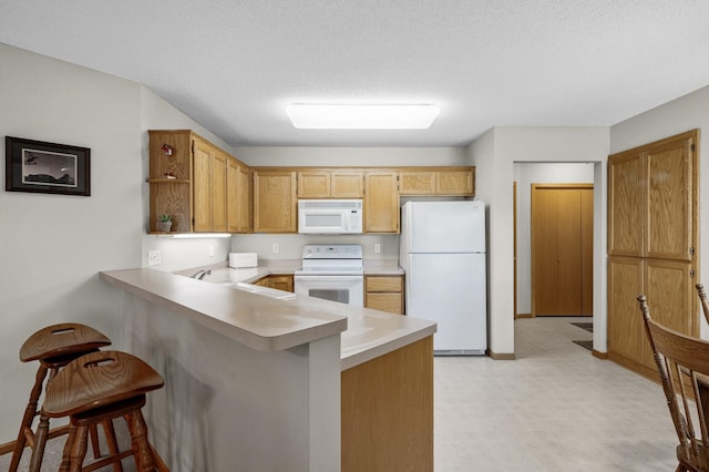 12 3rd St NW, Saint Michael, MN 55376 - kitchen featuring white appliances, a peninsula, open shelves, light countertops, and a kitchen bar