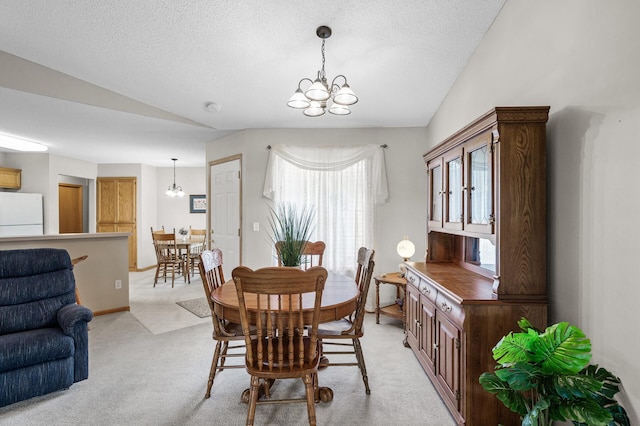 12 3rd St NW, Saint Michael, MN 55376 - dining room with a chandelier, vaulted ceiling, plenty of natural light, light colored carpet, and a textured ceiling