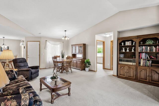 12 3rd St NW, Saint Michael, MN 55376 - living room featuring vaulted ceiling, a chandelier, light colored carpet, and healthy amount of natural light
