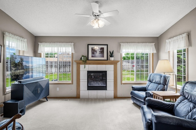 12 3rd St NW, Saint Michael, MN 55376 - living area with plenty of natural light, carpet, a textured ceiling, ceiling fan, and a tiled fireplace