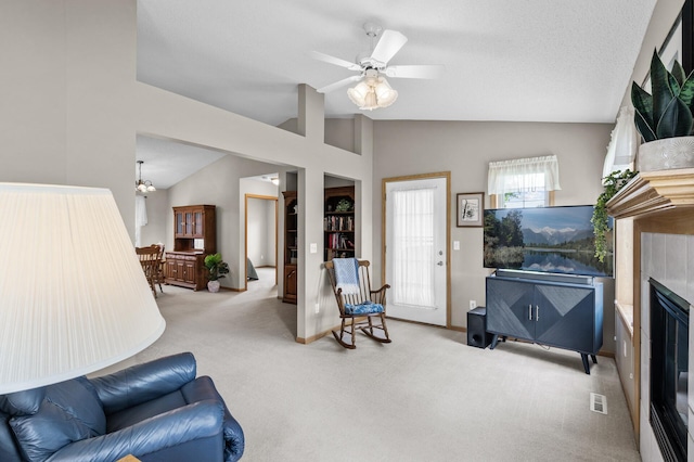 12 3rd St NW, Saint Michael, MN 55376 - carpeted living room with vaulted ceiling, a tile fireplace, and a ceiling fan