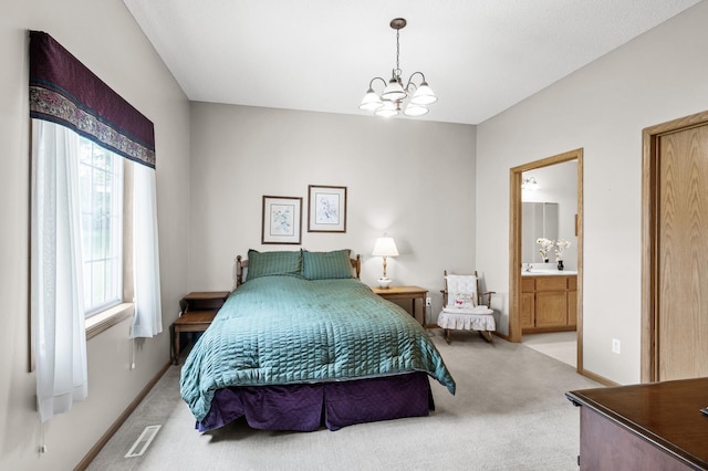 12 3rd St NW, Saint Michael, MN 55376 - bedroom featuring light colored carpet, a chandelier, and ensuite bathroom