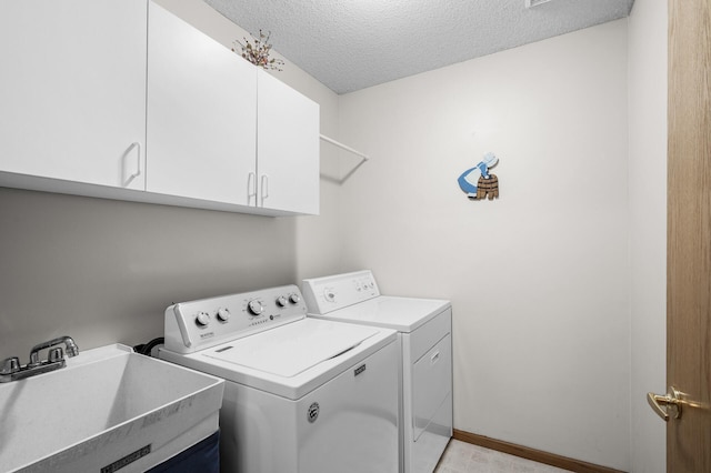 12 3rd St NW, Saint Michael, MN 55376 - laundry room with washer and dryer, cabinet space, and a textured ceiling