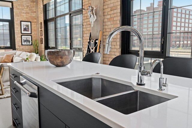 525 3rd St N Unit 511, Minneapolis, MN 55401 - kitchen view of brick wall, light countertops, modern cabinets, and dishwasher