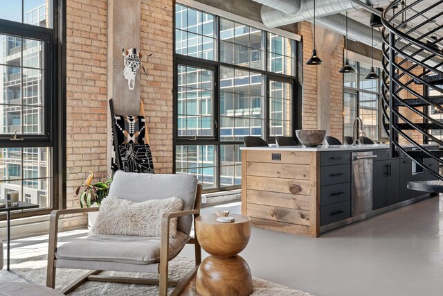 525 3rd St N Unit 511, Minneapolis, MN 55401 - interior space with brick wall, healthy amount of natural light, concrete floors, and a high ceiling