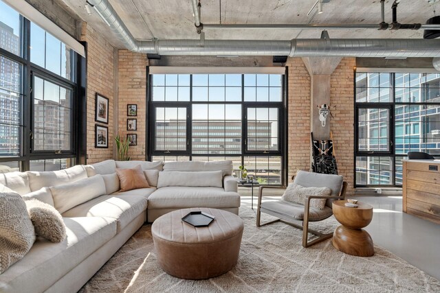 525 3rd St N Unit 511, Minneapolis, MN 55401 - living room featuring a high ceiling, brick wall, healthy amount of natural light, and rail lighting