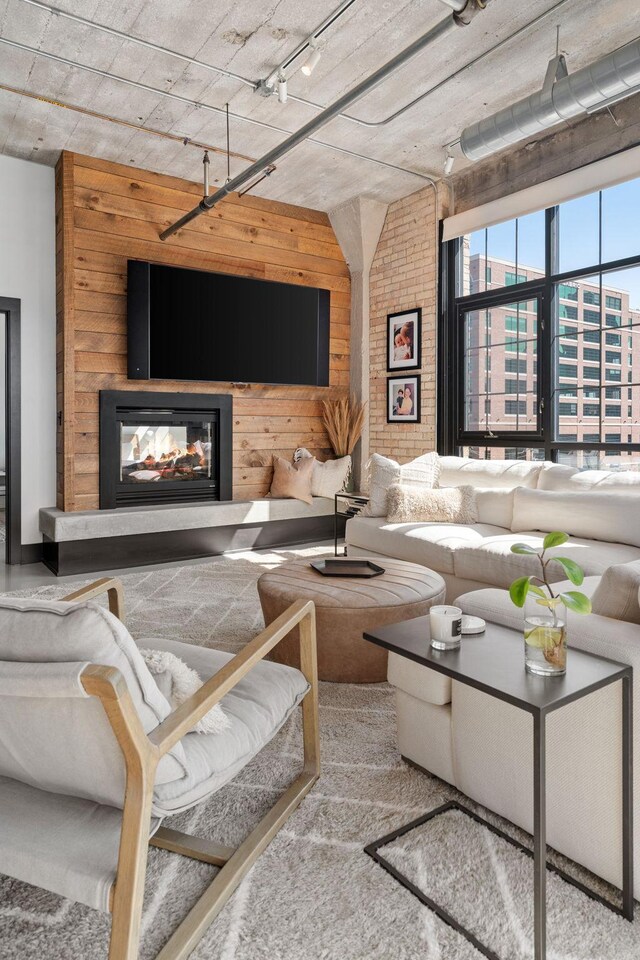 525 3rd St N Unit 511, Minneapolis, MN 55401 - living area featuring a multi sided fireplace, wood walls, and track lighting