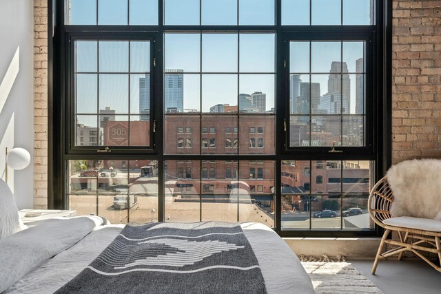 525 3rd St N Unit 511, Minneapolis, MN 55401 - bedroom with a city view, concrete floors, and brick wall