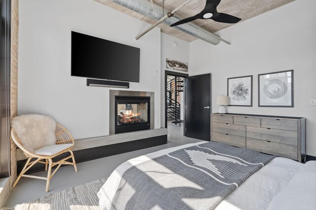 525 3rd St N Unit 511, Minneapolis, MN 55401 - bedroom featuring concrete flooring, a multi sided fireplace, and a high ceiling