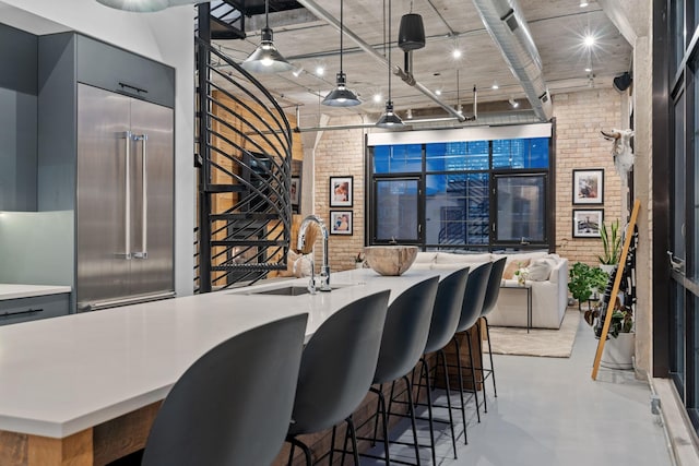 525 3rd St N Unit 511, Minneapolis, MN 55401 - bar area with brick wall, concrete flooring, stainless steel built in fridge, and decorative light fixtures