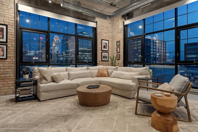525 3rd St N Unit 511, Minneapolis, MN 55401 - living room featuring a high ceiling, brick wall, carpet flooring, and a city view