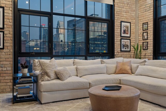 525 3rd St N Unit 511, Minneapolis, MN 55401 - living area with brick wall, carpet floors, a high ceiling, and a view of city