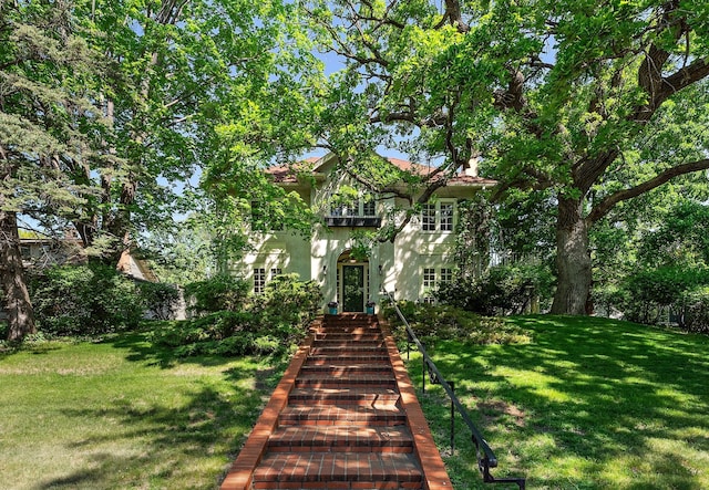 2181 Carter Ave, Saint Paul, MN 55108 - view of front of property featuring stucco siding, a front lawn, and a balcony