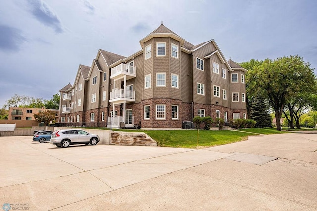 404 8th St S Unit 303, Fargo, ND 58103 - view of building exterior featuring uncovered parking and central air condition unit