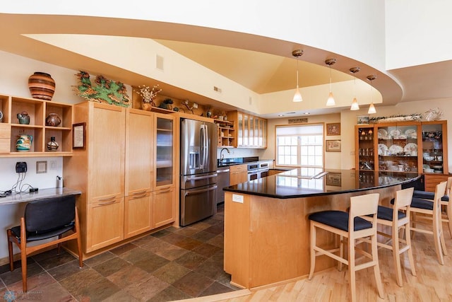404 8th St S Unit 303, Fargo, ND 58103 - kitchen featuring stainless steel appliances, open shelves, a kitchen breakfast bar, dark countertops, and a kitchen island