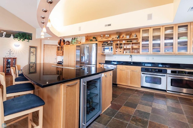 404 8th St S Unit 303, Fargo, ND 58103 - kitchen with stainless steel appliances, beverage cooler, dark countertops, lofted ceiling, and a sink