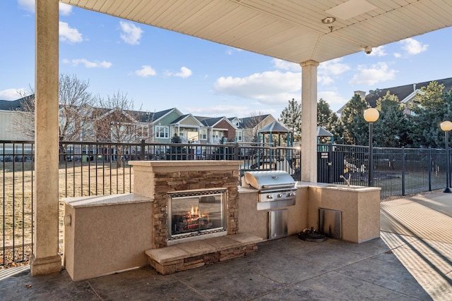 6665 Flycatcher Ln Unit 4130, Apple Valley, MN 55124 - view of patio / terrace featuring a playground, a residential view, and an outdoor stone fireplace