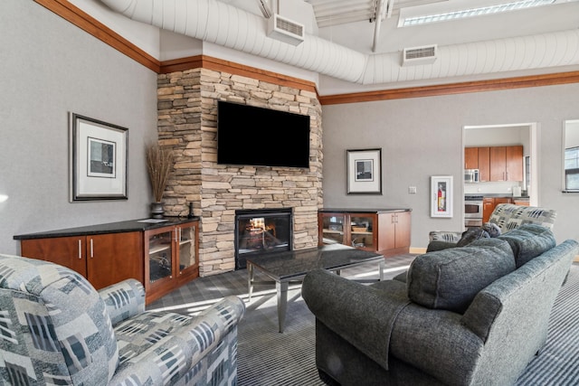 6665 Flycatcher Ln, Apple Valley, MN 55124 - living room featuring a high ceiling, a stone fireplace, and beam ceiling
