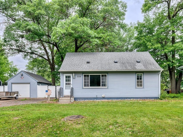 7338 Silver Lake Rd, Mounds View, MN 55112 - view of front of home with a detached garage, an outdoor structure, a front yard, and a shingled roof