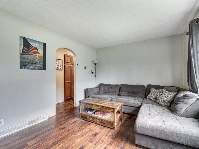 7338 Silver Lake Rd, Mounds View, MN 55112 - living room featuring arched walkways, wood finished floors, and a textured ceiling