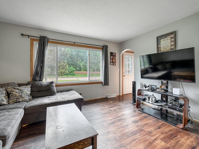 7338 Silver Lake Rd, Mounds View, MN 55112 - living area featuring arched walkways, wood finished floors, and a textured ceiling
