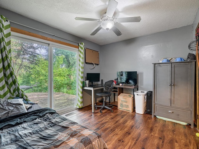 7338 Silver Lake Rd, Mounds View, MN 55112 - bedroom with a textured ceiling, dark wood-style flooring, an office area, and ceiling fan