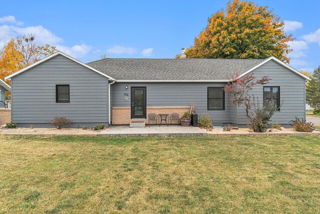 506 8th Ave SW, Pipestone, MN 56164 - rear view of house featuring a yard, roof with shingles, and a patio