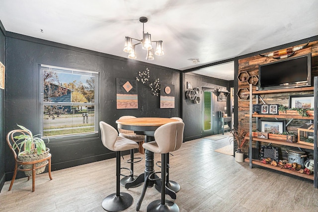 506 8th Ave SW, Pipestone, MN 56164 - dining area featuring wood finished floors, a chandelier, and baseboards