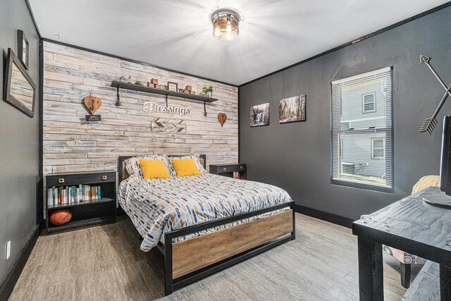 506 8th Ave SW, Pipestone, MN 56164 - bedroom featuring wood finished floors, wood walls, and baseboards