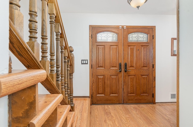 4248 Westview Dr, Shoreview, MN 55126 - foyer entrance featuring stairs, baseboards, and light wood-style flooring