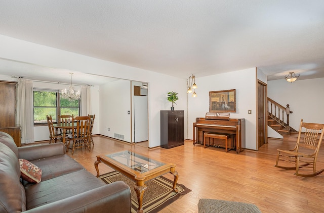 4248 Westview Dr, Shoreview, MN 55126 - living area with a chandelier, stairs, and light wood-style floors