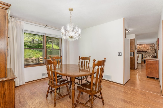 4248 Westview Dr, Shoreview, MN 55126 - dining space featuring light wood-type flooring, a chandelier, and baseboards
