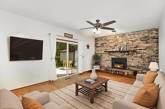 4248 Westview Dr, Shoreview, MN 55126 - living room featuring a ceiling fan, wood finished floors, a brick fireplace, and baseboards