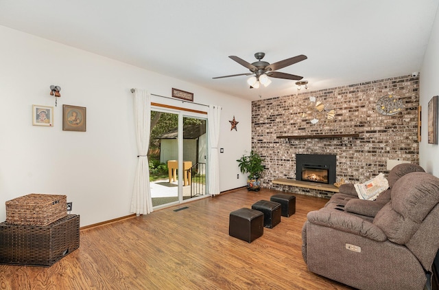 4248 Westview Dr, Shoreview, MN 55126 - living room featuring ceiling fan, wood finished floors, a brick fireplace, and baseboards