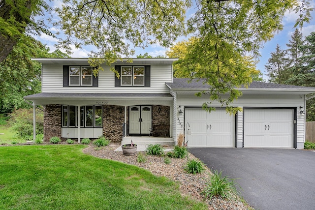 4248 Westview Dr, Shoreview, MN 55126 - traditional-style house with a garage, driveway, a front yard, and brick siding