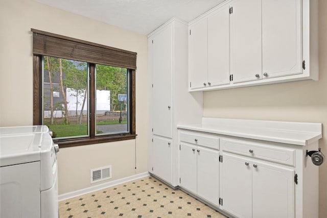 2725 Pilgrim Ln N, Plymouth, MN 55441 - laundry area featuring separate washer and dryer, cabinet space, and light flooring